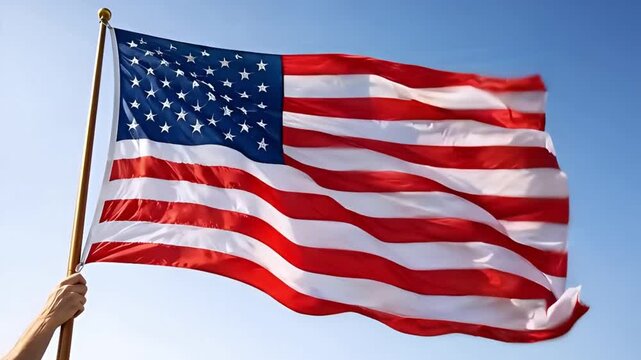A vibrant national flag, representing principles of freedom and unity, proudly waves against a clear blue sky, symbolizing national pride and independence