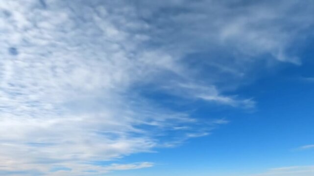 sunlit clouds forming patterns across sky