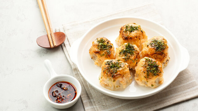 Dimsum with Japanese Mentai Sauce. Served on plate.
