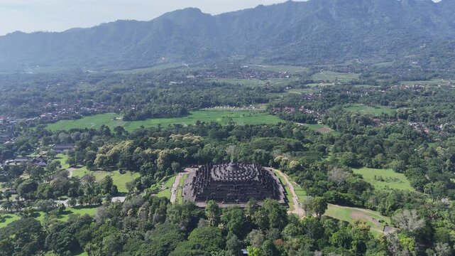 Aerial drone fly-in to Borobudur temple, the world largest Buddhist monument at sunrise, Central Java, Indonesia