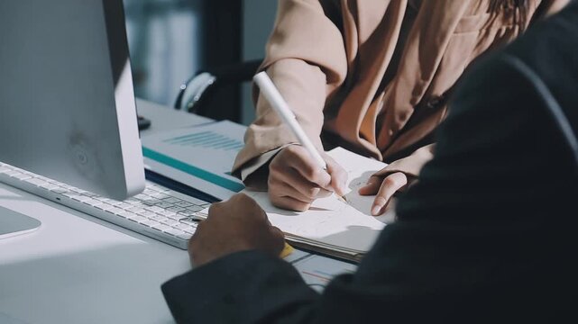 Accountant reviewing printed financial reports at messy office desk with calculator and sticky notes under soft window daylight for audit and corporate finance work