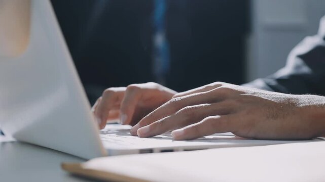 Accountant reviewing printed financial reports at messy office desk with calculator and sticky notes under soft window daylight for audit and corporate finance work