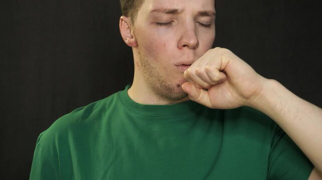 Young man suffering from sore throat and illness at work