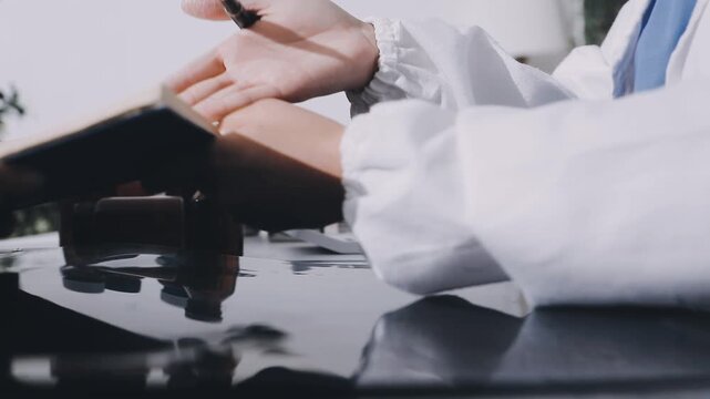 Hands of chief physician working on computer when having online meeting with colleague from another hospital or laboratory