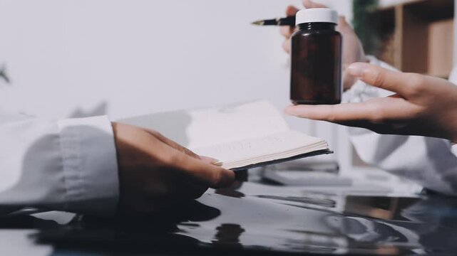 Hands of chief physician working on computer when having online meeting with colleague from another hospital or laboratory