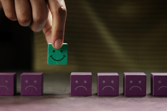 Mind, Mental Health Concept. Hand Picking a Unique Smiling Cube