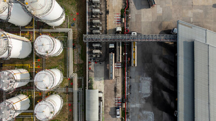 Aerial view of industrial oil storage tank farm and distribution terminal with tanker truck, Fuel reserves and oil refinery infrastructure, Fuel distribution center energy product fuel storage tank. © Kalyakan