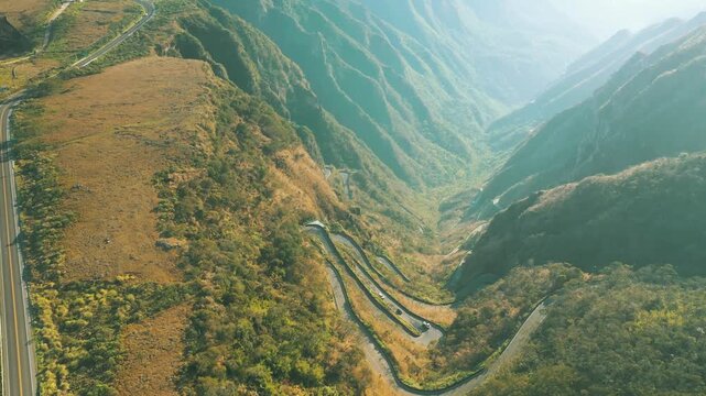 Drone aerial over Serra do Rio do Rastro in Bom Jardim da Serra, Brazil, winding mountain road weaving through dramatic canyon landscapes, cinematic adventure scenery filmed October 08, 2025.