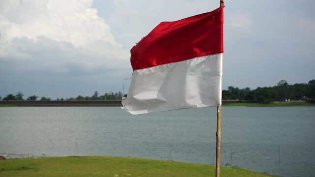 The single large red and white Indonesian flag flutters in the strong wind ahead of the 81th Independence Day of the Republic of Indonesia.