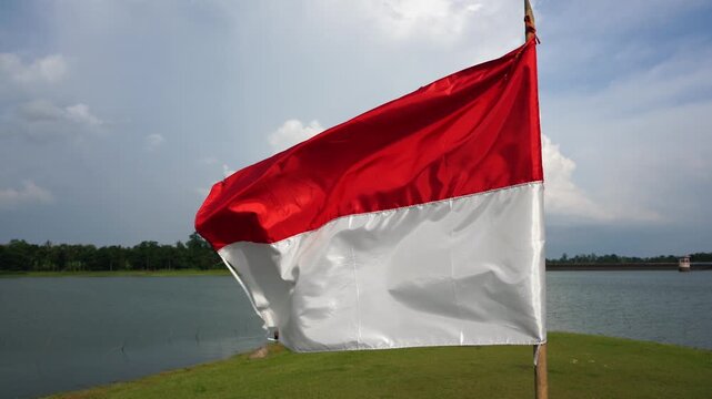 The single large red and white Indonesian flag flutters in the strong wind ahead of the 81th Independence Day of the Republic of Indonesia.