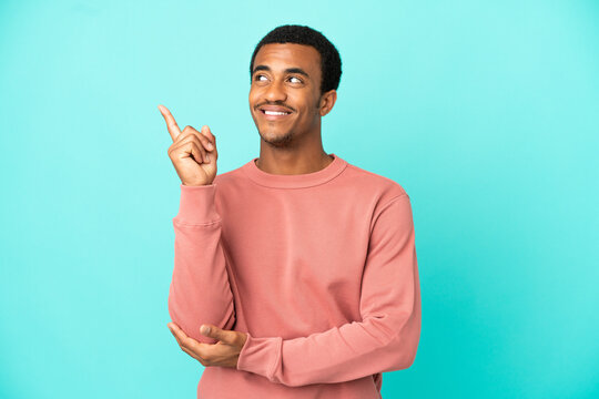 African American handsome man on isolated blue background pointing up a great idea