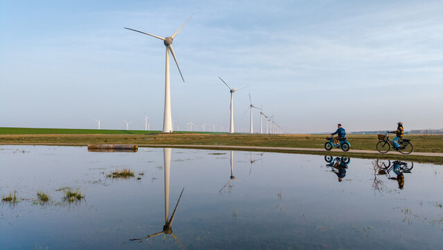 Exploring sustainable energy through windmills in Urk, Flevoland on a clear day