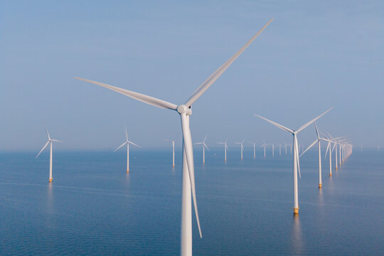 Captivating view of wind turbines in Tollebeek, Flevoland, showcasing renewable energy in action