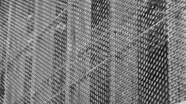 Woven plaid texture shows worn wool fibers in charcoal tones