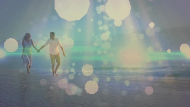 Clip starting with pair entering left, pair walking holding hands toward sun, sharing sunset bokeh