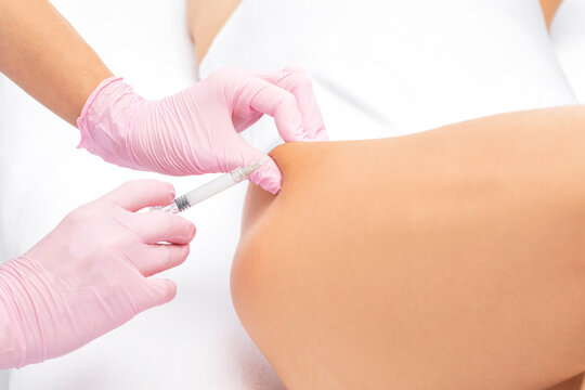 A doctor of aesthetic cosmetology makes lipolytic injections to burn body fat on a woman&rsquo;s on the hips, legs and thighs . Female aesthetic cosmetology in a beauty salon.