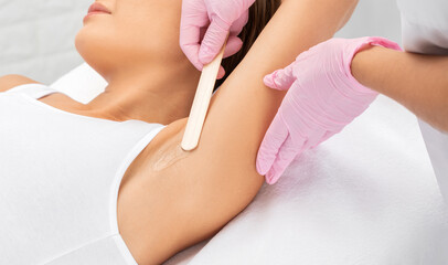 Elos epilation hair removal procedure on a woman’s body. Beautician doing laser rejuvenation in a...