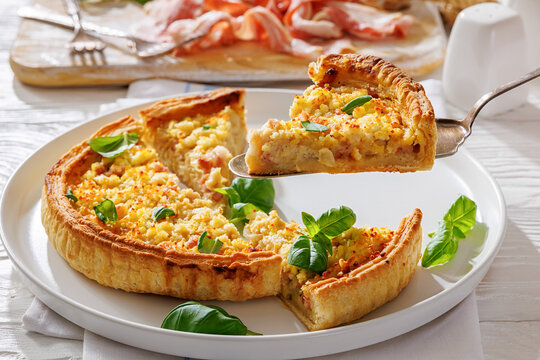 Slice of Quiche Lorraine on a spatula on a plate