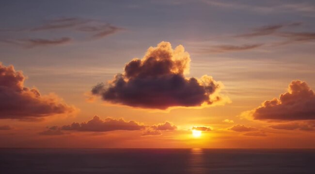 A vibrant sunset paints the sky with fiery clouds above a calm ocean horizon