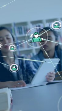 Vertical video: Pair studying in library after pause tablet showing avatars linking into study web