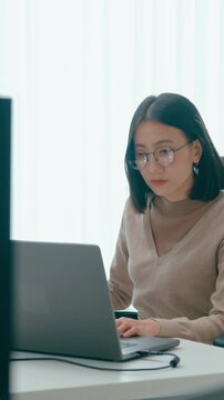 Vertical Screen : Young adult Asia female freelance eyeglasses typing write prompt AI bot app smart program nomad, video game, terminal coding, user interface, designer, big data center on computer.