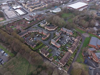Fototapeta premium Drone shot of Liverpool showing housing areas with chimneys and warehouses in the distance.