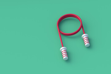 Skipping rope on green background. Jumping cord. Sports equipment. Toy for children. Fitness accessories. Copy space. 3d render