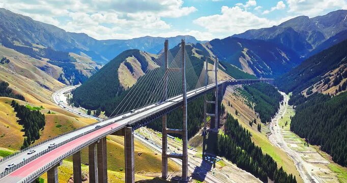 Aerial view of Guozigou cable-stayed bridge spanning a mountain valley in Xinjiang, China.