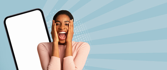 A woman shows excitement and joy while standing near a smartphone. The background features vibrant...