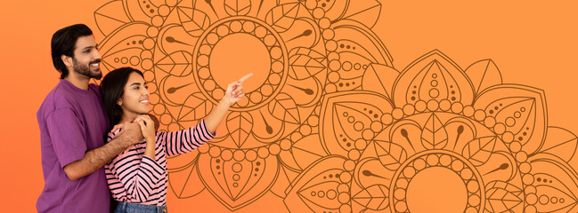 A couple stands closely, the man smiling while the woman points at something in the distance. Colorful patterns fill the background, adding a festive touch to their joyful moment together. © Prostock-studio