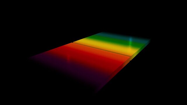 Rainbow spectrum light projected onto a flat rectangular surface in a dark room with a moody colorful prism effect and high contrast lighting