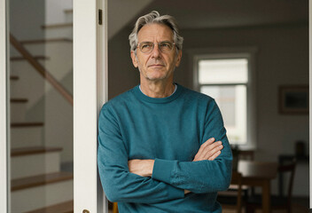 Fototapeta premium Thoughtful Middle Aged Man Standing in Doorway