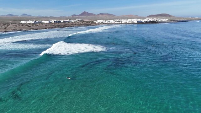 Aerial drone view of waves crashing into the harbor in Lanzarote island 