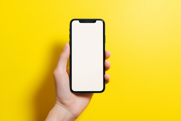 Hand holding smartphone with blank screen , bright clean background