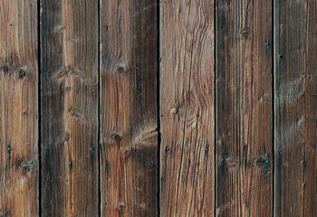 Fototapeta premium Wooden planks arranged in a vertical pattern show natural grain and textures in a simple wooden surface