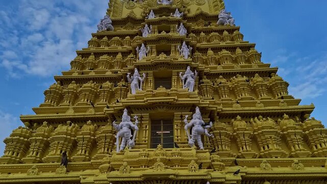 Drone view of the golden gopuram of Sri Chamundeshwari Temple adorned with goddess sculptures