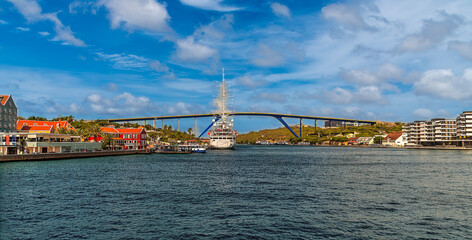 Fototapeta premium A view up the Saint Anna Bay towards the Queen Juliana Bridge in Willemstad, Curacao on a bright morning