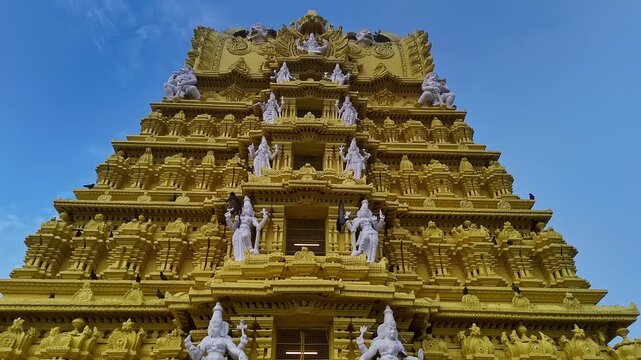 Drone view of the golden gopuram of Sri Chamundeshwari Temple adorned with goddess sculptures