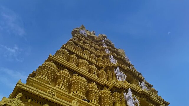 Drone view of the golden gopuram of Sri Chamundeshwari Temple adorned with goddess sculptures