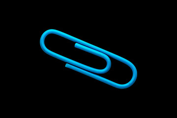 Obraz premium Blue metal paper clip cut out and isolated on a black background, minimal studio stock photo of a single office stationery item