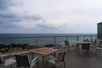 outdoor cafe and overcast seascape at Seopjikoji in Jeju Island, South Korea