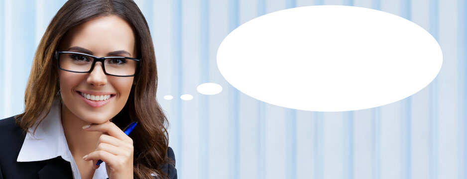 Portrait image - bright smile business woman businesswoman teacher, bank manager. Brunette girl in black eye glasses, eyeglasses, suit jacket on office background. White empty speech think bubble