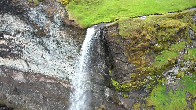 Waterfall falling into the sea in Iceland, view from above.