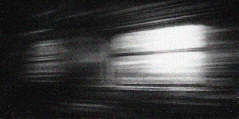 Vintage film projector lens creates a blue light flare through falling rain as a man stands against a dark textured grunge wall backdrop © Abdul