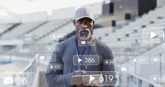 Animation of notification icons with changing numbers over african american coach using tablet