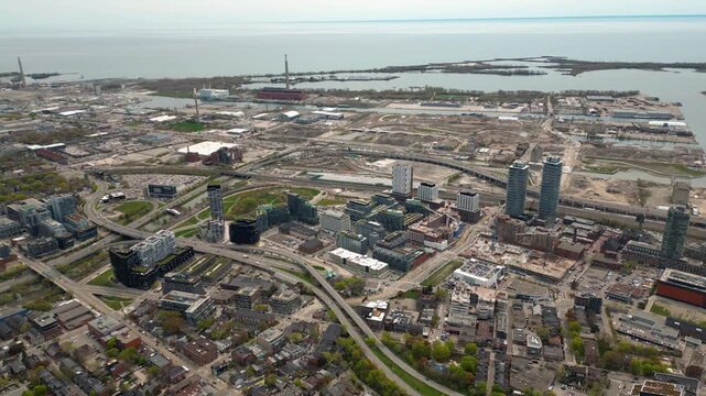 Aerial View of Toronto's Massive Waterfront Port Lands Redevelopment with Lake Ontario Beyond