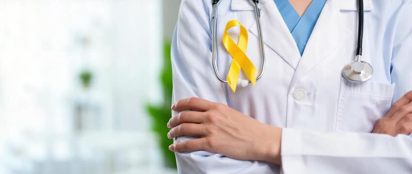 Doctor with yellow ribbon on lab coat raising endometriosis awareness, ongoing care for patients living with condition, pelvic pain recognition, diagnosis delay advocacy, fertility options