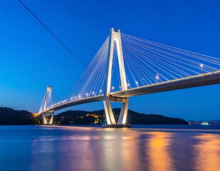 Obraz premium Illuminated Cable-Stayed Bridge at Night - A Modern Architectural Marvel.