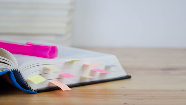 Book instruction manual reference sticky paper note blur background.