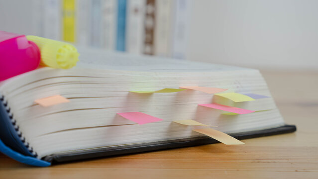 Book instruction manual reference sticky paper note blur background.
